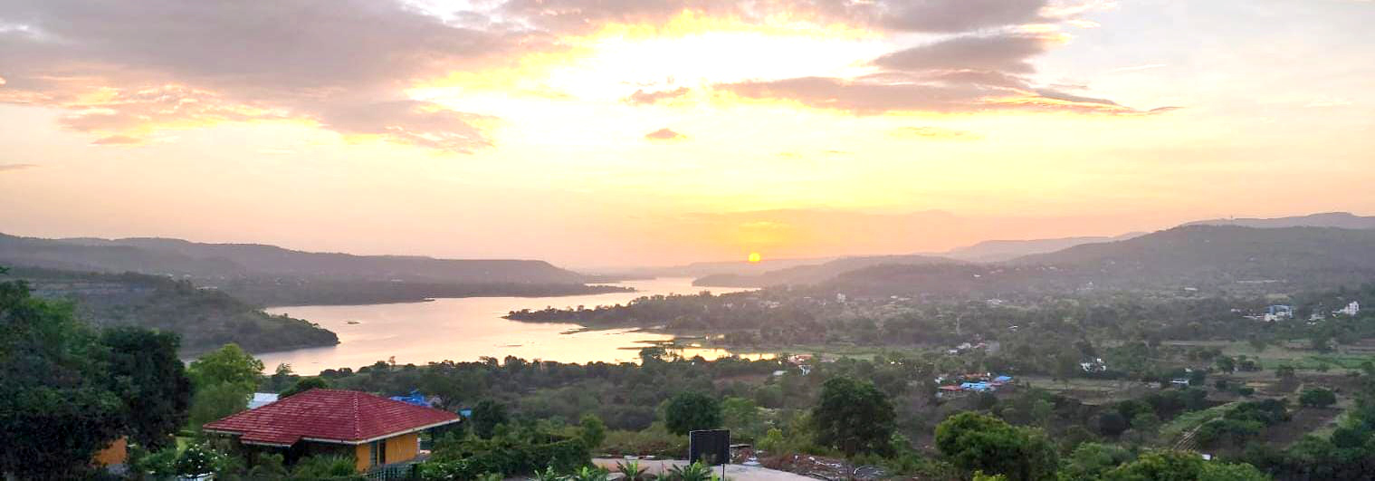 Sunset over hills and water near the Club Deeper campus